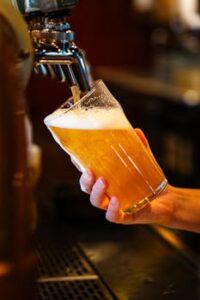 Closeup of a draft beer being poured into a pint glass at a bar in Montreal, Canada.