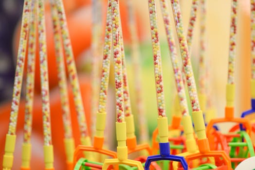 Close-up of vibrant beaded toy wands with colorful handles
